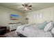 Main bedroom with large TV, dresser, and ceiling fan at 21268 N 266Th Ln, Buckeye, AZ 85396