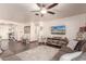 Comfortable living room with hardwood floors and large TV at 21268 N 266Th Ln, Buckeye, AZ 85396