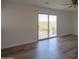 Bedroom with wood floor and sliding door to balcony at 22155 N Cline Ct, Maricopa, AZ 85138