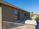 Tan house exterior with sliding glass doors leading to a patio at 22155 N Cline Ct, Maricopa, AZ 85138