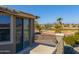 Home exterior showcasing sliding glass doors and a balcony overlooking the golf course at 22155 N Cline Ct, Maricopa, AZ 85138