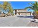 Two-story home with a three car garage and palm trees at 22155 N Cline Ct, Maricopa, AZ 85138