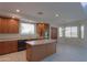 Kitchen with island, wood cabinets, and stainless steel appliances at 22155 N Cline Ct, Maricopa, AZ 85138