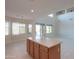 Open kitchen with breakfast nook and view to living area at 22155 N Cline Ct, Maricopa, AZ 85138