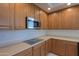 Modern kitchen featuring cooktop and ample storage at 22155 N Cline Ct, Maricopa, AZ 85138