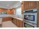 Kitchen with stainless steel appliances and wood cabinets at 22155 N Cline Ct, Maricopa, AZ 85138