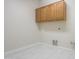 Laundry room with wooden cabinets and tile floors at 22155 N Cline Ct, Maricopa, AZ 85138