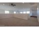 Spacious loft area with carpeted floor and ceiling fan at 22155 N Cline Ct, Maricopa, AZ 85138