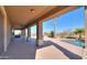 Covered patio with ceiling fans overlooking the pool and backyard at 22155 N Cline Ct, Maricopa, AZ 85138