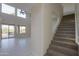 Elegant staircase with carpeted steps and glass enclosure at 22155 N Cline Ct, Maricopa, AZ 85138