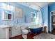 Updated bathroom with pedestal sink, clawfoot tub, and wood floors at 2614 N 15Th St, Phoenix, AZ 85006