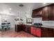 Modern kitchen with dark wood cabinets, a red range, and granite countertops at 2614 N 15Th St, Phoenix, AZ 85006