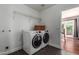 Laundry room with washer, dryer, and ample shelving at 2614 N 15Th St, Phoenix, AZ 85006