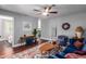 Living room with blue velvet sofa, wood floors, and ceiling fan at 2614 N 15Th St, Phoenix, AZ 85006