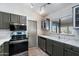 View of kitchen with gray cabinets and stainless steel appliances at 2722 Leisure World --, Mesa, AZ 85206