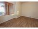 Bright bedroom with wood-look flooring and large window at 2740 S Honeysuckle Ln, Gilbert, AZ 85295