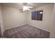 Bright bedroom with ceiling fan and neutral carpeting at 2740 S Honeysuckle Ln, Gilbert, AZ 85295