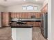 Modern kitchen featuring wood cabinets, granite countertops, and island at 2740 S Honeysuckle Ln, Gilbert, AZ 85295