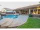 Relaxing pool area with a waterfall and spacious patio at 2740 S Honeysuckle Ln, Gilbert, AZ 85295