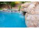 Close-up of a gorgeous rock waterfall cascading into a pool at 2740 S Honeysuckle Ln, Gilbert, AZ 85295