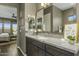 Modern bathroom with granite countertops and a large mirror at 28219 N Needle Rock Ct, Rio Verde, AZ 85263