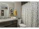 Modern bathroom with granite vanity, shower, and patterned shower curtain at 28219 N Needle Rock Ct, Rio Verde, AZ 85263