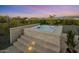 Relaxing hot tub with stone surround and steps at 28219 N Needle Rock Ct, Rio Verde, AZ 85263