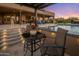 Backyard patio with steps leading to the pool and seating area at 28219 N Needle Rock Ct, Rio Verde, AZ 85263