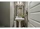 Stylish powder room with pedestal sink and geometric tile at 28219 N Needle Rock Ct, Rio Verde, AZ 85263