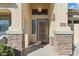 Elegant front entry with decorative door and stone accents at 2910 E Quiet Hollow Ln, Phoenix, AZ 85024