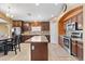 Modern kitchen with granite countertops, dark wood cabinets, and an island at 2910 E Quiet Hollow Ln, Phoenix, AZ 85024