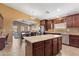 Open kitchen with granite counters, island, and view into Gathering room at 2910 E Quiet Hollow Ln, Phoenix, AZ 85024