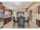 Kitchen boasts dark wood cabinets and an eat-in kitchen island at 2910 E Quiet Hollow Ln, Phoenix, AZ 85024