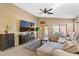 Bright living room featuring a comfy sectional sofa and large TV at 2910 E Quiet Hollow Ln, Phoenix, AZ 85024