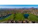 Aerial view of golf course with two lakes and surrounding desert landscape at 3055 N Red Mountain Rd # 149, Mesa, AZ 85207