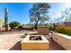 Landscaped backyard with fire pit and built-in grill at 3055 N Red Mountain Rd # 149, Mesa, AZ 85207