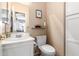 Clean bathroom with white vanity, toilet and built-in shelving at 3055 N Red Mountain Rd # 149, Mesa, AZ 85207