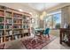 Dining area with built-in bookcase, chandelier, and table with chairs at 3055 N Red Mountain Rd # 149, Mesa, AZ 85207