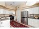 Kitchen with stainless steel refrigerator and white cabinets at 3055 N Red Mountain Rd # 149, Mesa, AZ 85207