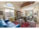 Living area featuring a blue couch, large bookcase and glass coffee table at 3055 N Red Mountain Rd # 149, Mesa, AZ 85207