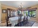 Bright dining room with backyard view, large table, and chandelier at 3606 W Le Marche Ave, Phoenix, AZ 85053