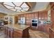 Spacious kitchen with granite island and wooden cabinetry at 3606 W Le Marche Ave, Phoenix, AZ 85053