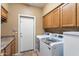 Laundry room with washer, dryer, cabinets, and countertop at 3606 W Le Marche Ave, Phoenix, AZ 85053