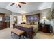 Spacious main bedroom with a king-size bed and attached bathroom at 3606 W Le Marche Ave, Phoenix, AZ 85053