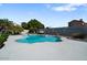 Freeform swimming pool surrounded by a stone patio at 3606 W Le Marche Ave, Phoenix, AZ 85053