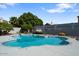 Freeform swimming pool with a large patio area at 3606 W Le Marche Ave, Phoenix, AZ 85053