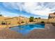 Inviting backyard oasis featuring a sparkling pool, ample patio space, and a covered patio at 36248 W Cartegna Ln, Maricopa, AZ 85138