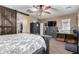 Spacious bedroom with a rustic wooden bed frame and ceiling fan at 36248 W Cartegna Ln, Maricopa, AZ 85138