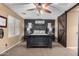 Bright bedroom featuring a dark wooden bed frame and ceiling fan at 36248 W Cartegna Ln, Maricopa, AZ 85138