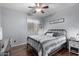 Bedroom with metal bed frame, ceiling fan, and wood flooring at 36248 W Cartegna Ln, Maricopa, AZ 85138